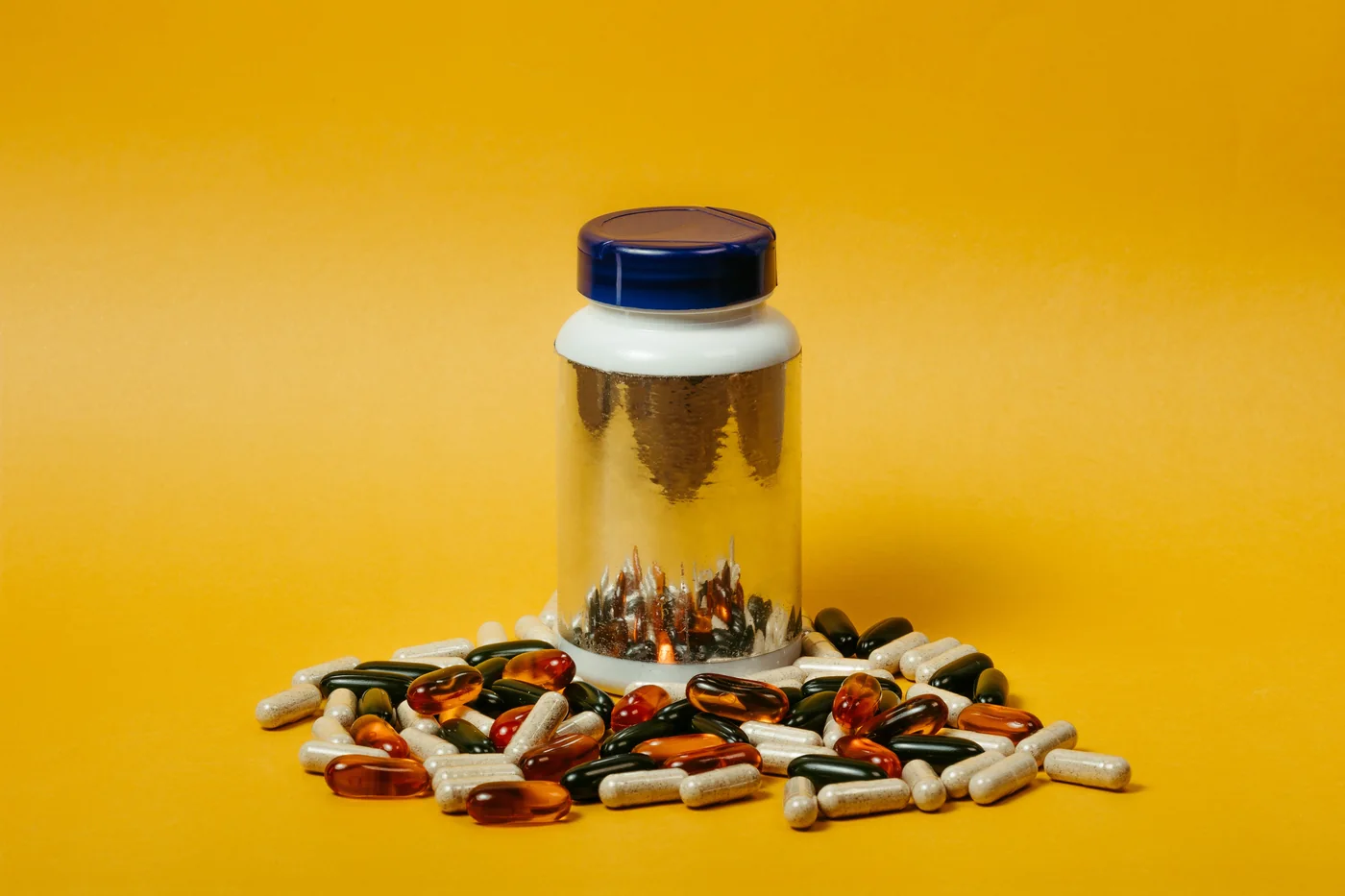 Illustrative assortment of capsules around a bottle